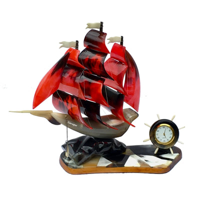 Decorative ship model with red sails and a clock on a white background